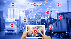 Jet, trucks, and containers are the backdrop and each item has a red dot with an icon that represents a step in the import-export process and a pair of feminine hands hold a table with a red dot on the screen that connects all the other dots