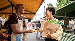 Person paying with phone for food outside