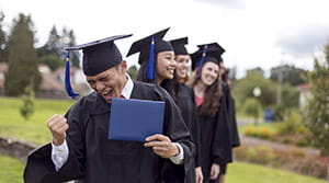 Graduate cheering with diploma