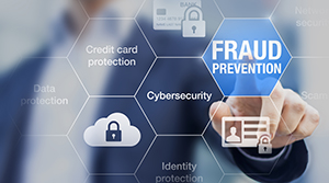 Man blurred in background touching a clear touchscreen pushing a button that reads Fraud Prevention