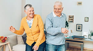 Older couple dancing in living room