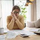 Person looking at papers and calculator