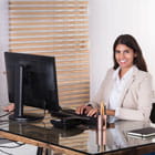 Woman sits in front of computer using Banner Bank's ADA accessible website