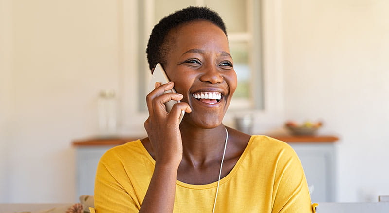 Person using cell phone and smiling