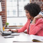 Woman sits at laptop and pays her credit card bill Banner Online Banking and Bill Pay