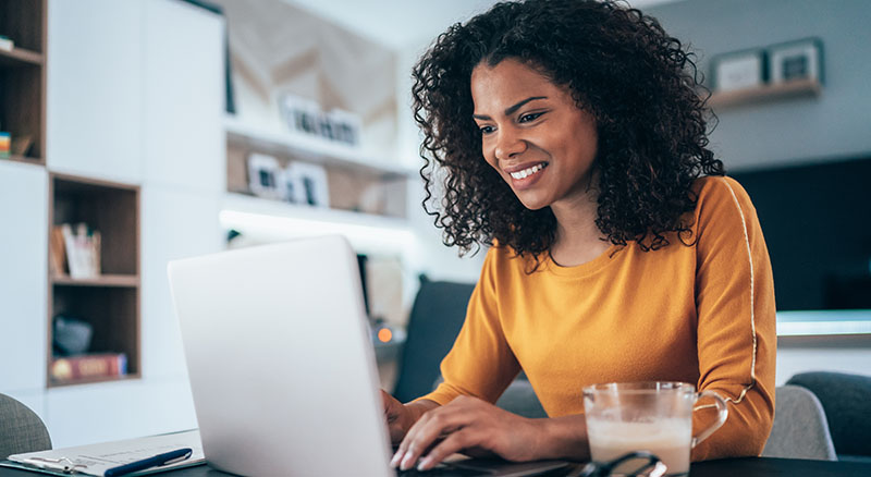 Person using laptop at home to manage Banner account