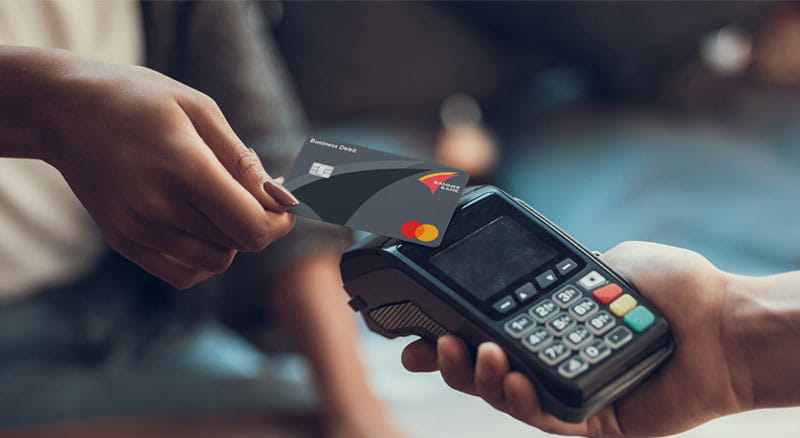 Businesswoman uses Banner Bank business debit card at point-of-sale terminal