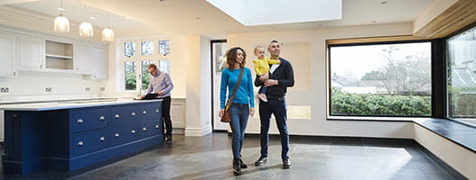 Family looking at a home with a realtor in background
