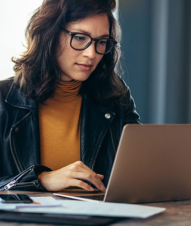 A woman in glasses learns about security on her laptop