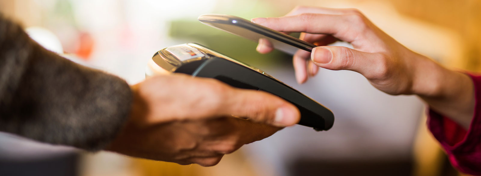 Woman pays using her mobile phone