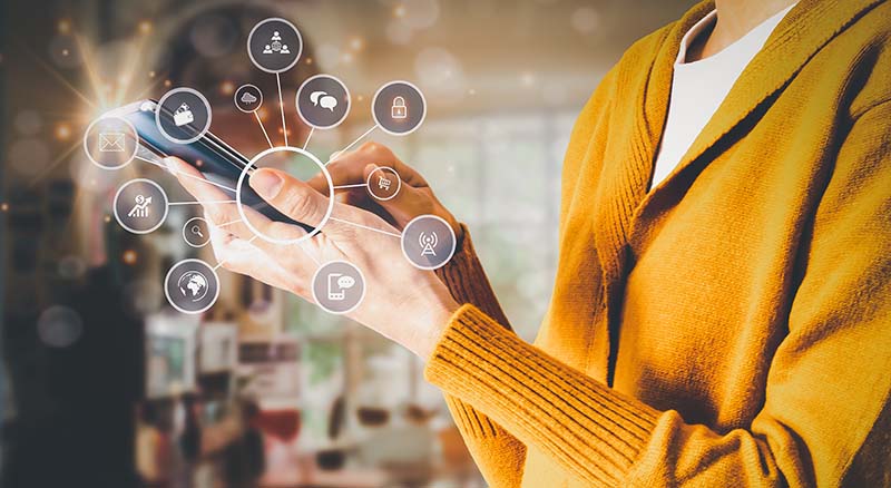 Person holding phone with icons of wallet, phone, text and email.