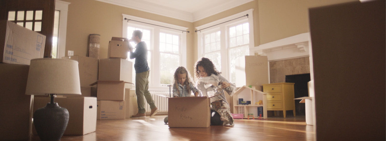 Family unpacks boxes in their new home