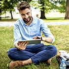 Person using tablet in a park