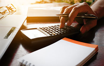 Man calculating expenses and savings for financial planning