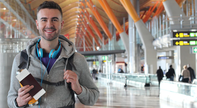 Man walk through airport with passport in hand