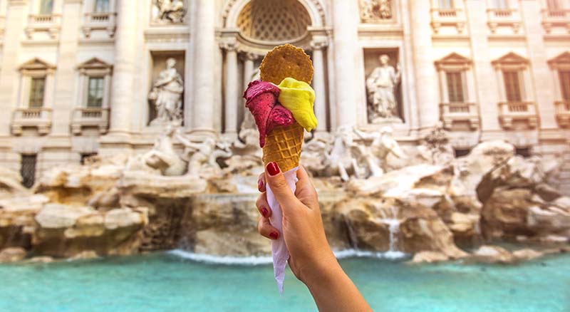 Hand holding gelato at tourist destination
