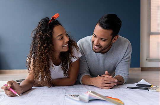 A couple review floor plans and color chips to plan improvements