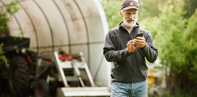 Farmer uses smartphone