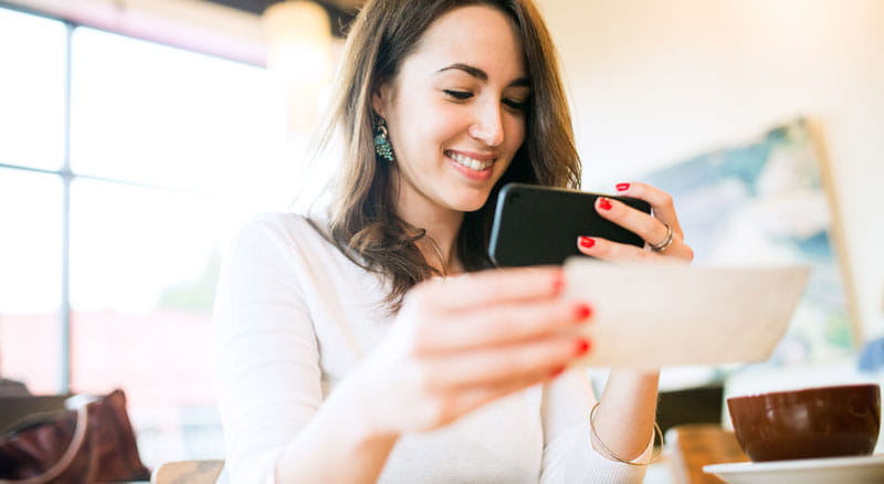 Woman deposits check using mobile banking app
