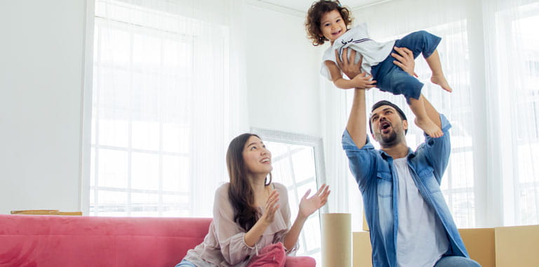 Parents hold child in air