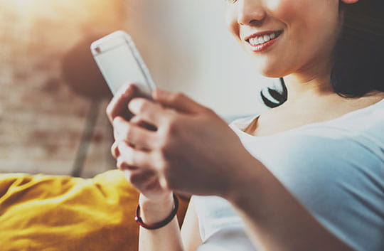 Close up of a woman using her mobile phone