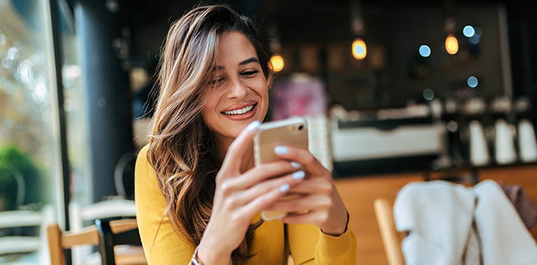 Person using phone at cafe