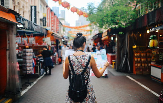 Woman looks at map in Asian market