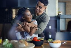husband and wife hugging in their kitchen