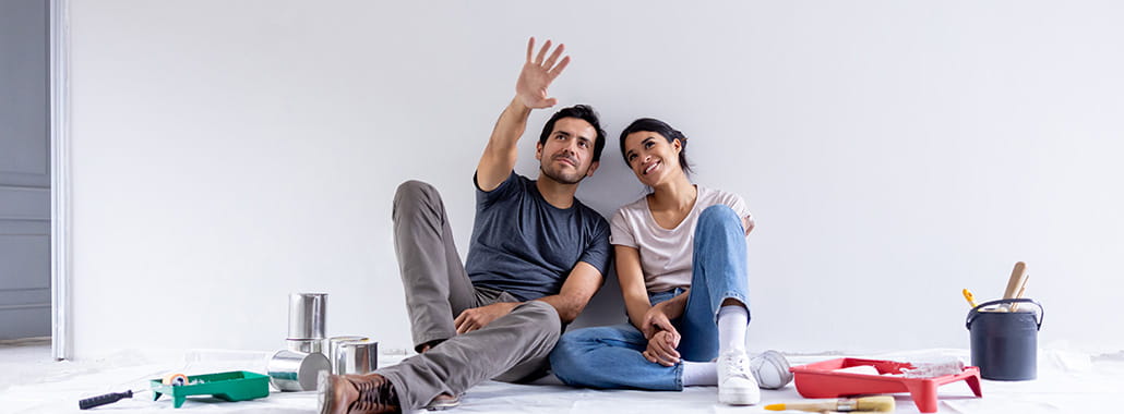 People looking at space in home and pointing