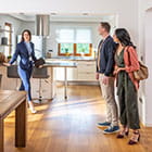 Two people looking at a home with a realtor