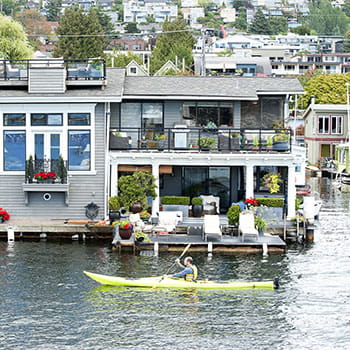 Kayak passing by a floating home