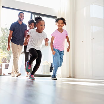 Family running into a new home