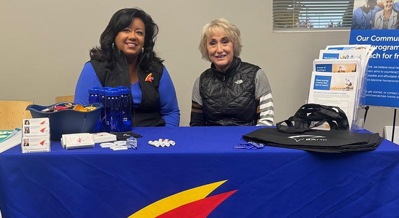 Two loan officers smiling at a Banner Bank table