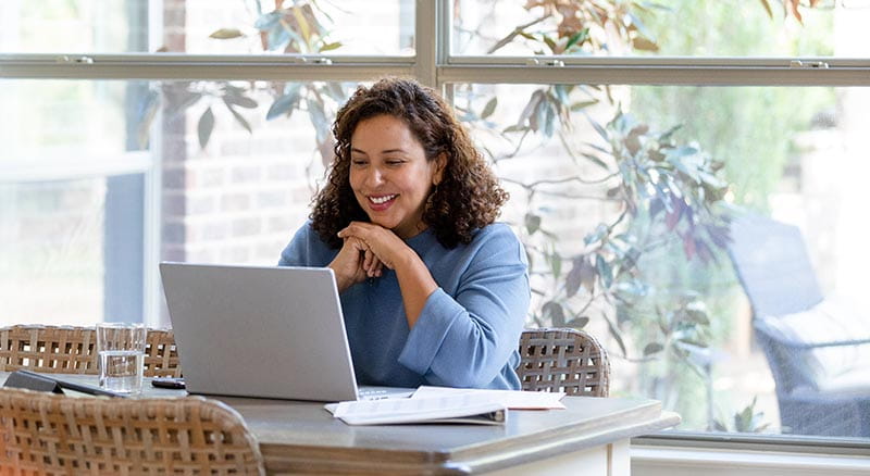 Person looking at laptop from kitchen table