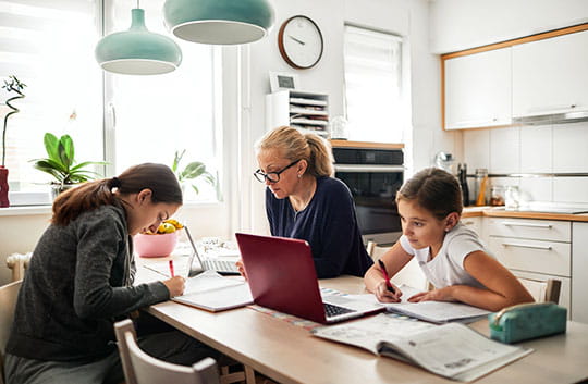 Family working at studying at kitchen table