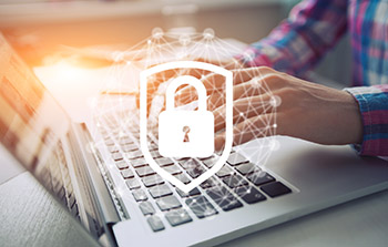 Person typing on laptop with secure lock symbol