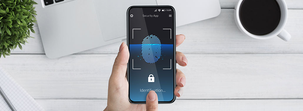 Person holding phone with fingerprint login on the screen