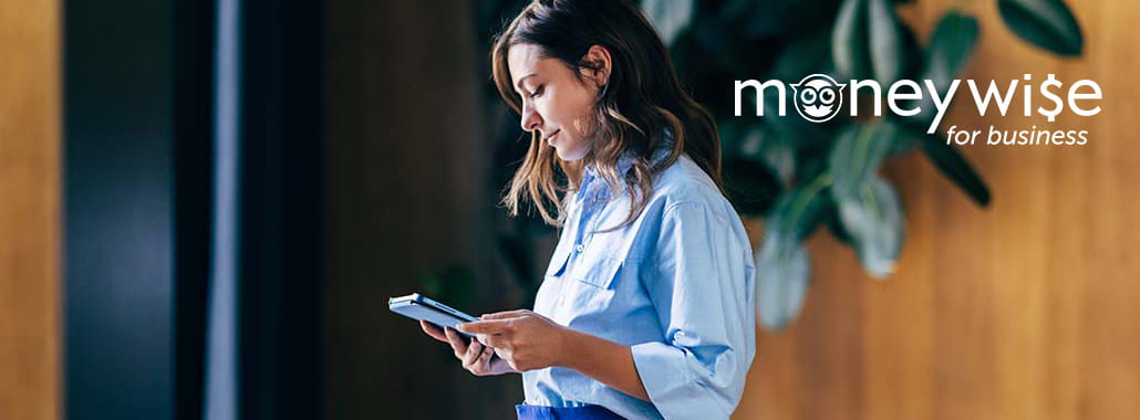 Person on tablet with moneywise for business logo