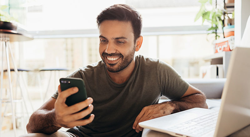 Person smiling while looking at phone