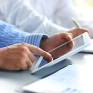 Business man accesses his accounts on a tablet with Banner Bank's Business Online Banking
