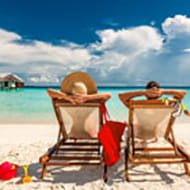 Couple lounges on sunny beach