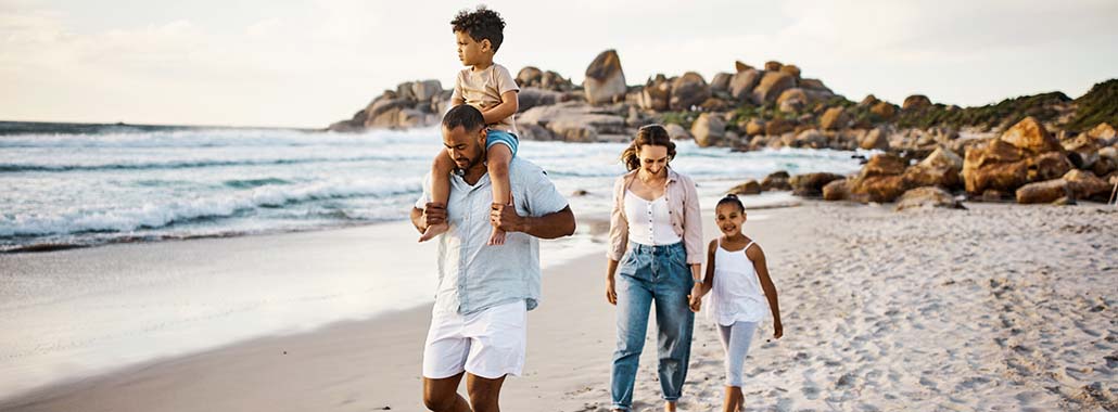Family of four walking on a beach