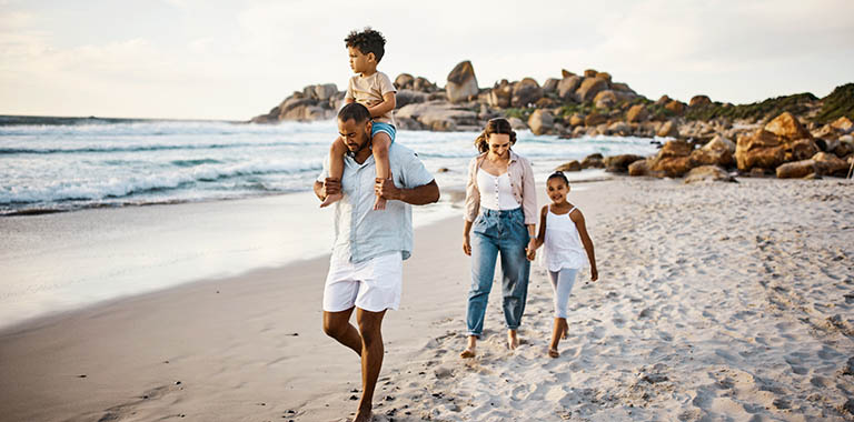 Family of four walking on a beach