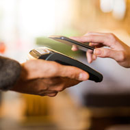 Woman pays using her mobile phone
