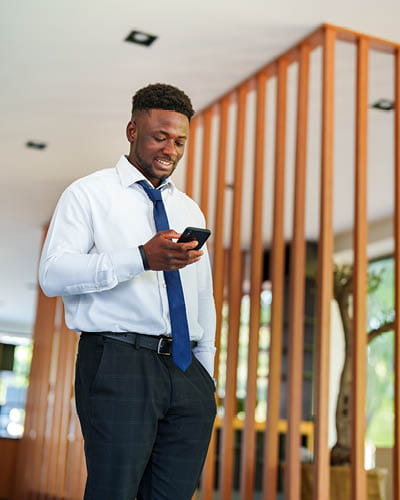 man holding his phone in an office