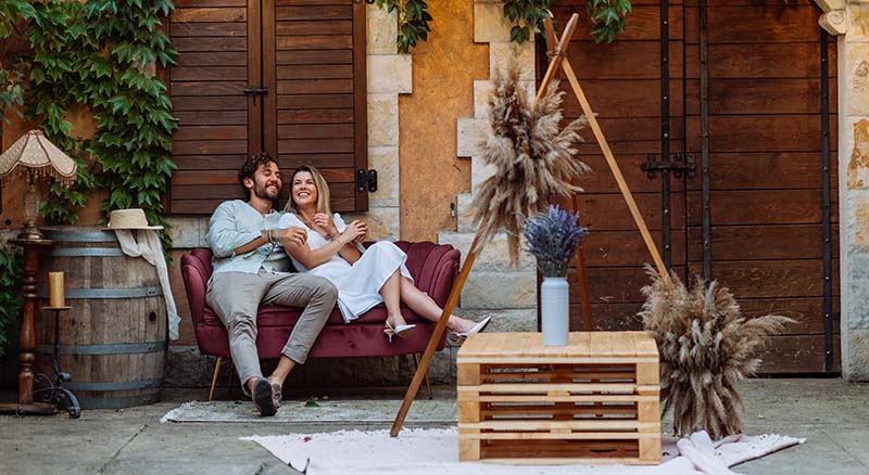 Man and woman relaxing on outdoor couch