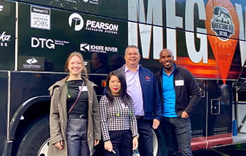 Manufacturing tour bus with Banner employees