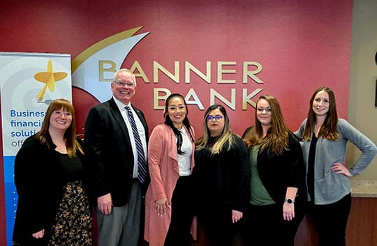 Ephrata team members in front of Banner Bank logo
