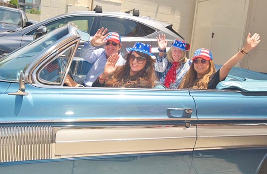 Banner employees in a car