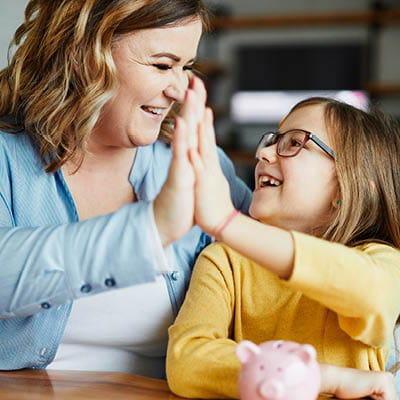 Mom and daughter high-fiving